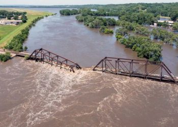 Midwestern flooding collapses a bridge, forces evacuations and kills at least 2