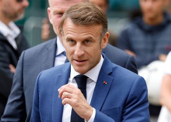 French President Emmanuel Macron walks prior to cast his vote in the first round of parliamentary elections at a polling station in Le Touquet, northern France on 30 June 2024. Photo: AFP