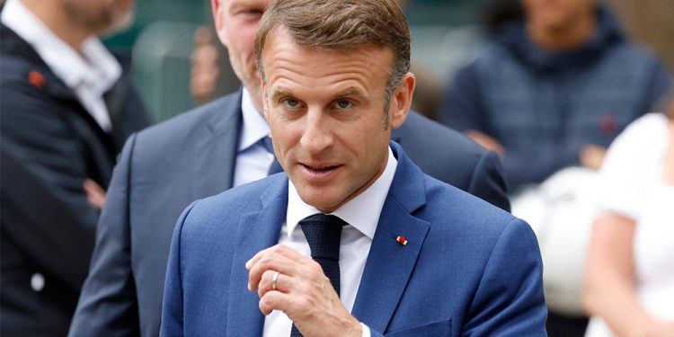 French President Emmanuel Macron walks prior to cast his vote in the first round of parliamentary elections at a polling station in Le Touquet, northern France on 30 June 2024. Photo: AFP