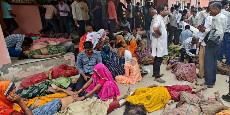 [3/3] SENSITIVE MATERIAL. THIS IMAGE MAY OFFEND OR DISTURB People mourn next to the bodies of victims of a stampede outside a hospital in Hathras district in the northern state of Uttar Pradesh, India, July 2, 2024. REUTERS