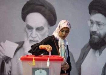 A woman casts her vote at a polling station during the run-off election for the Iranian presidential elections. Arne Bänsch/dpa