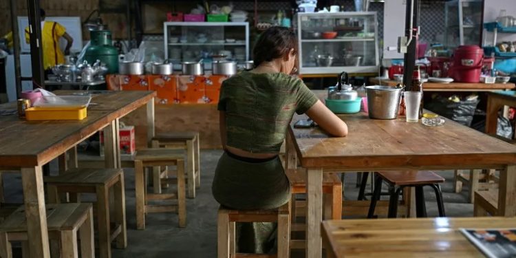 Tens of thousands of young people rights groups estimate have fled Myanmar since the military introduced conscription (Lillian SUWANRUMPHA)/afp