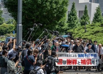 Lawyers and supporters of victims of forced sterilisation under a now-defunct eugenics law, carrying a banner demanding apologies and compensations, march toward the Supreme Court of Japan in Tokyo (Yuichi YAMAZAKI)/AFP
