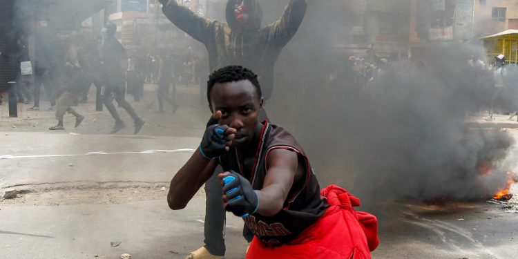 A man gestures during a demonstration over police killings of people protesting against the imposition of tax hikes by the government, in Nairobi, Kenya. REUTERS/Monicah Mwangi