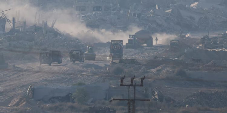 Israeli military vehicles and machinery drive inside Gaza, near the Israel-Gaza border, amid the Israel-Hamas conflict, as seen from Israel, July 3, 2024. REUTERS/Amir Cohen