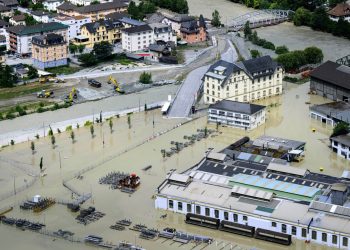 The Rhone in Chippis, Switzerland, overflowed due to ferocious storms and torrential rains, leading to flooding of a highway and a railway line close by. Photograph: Jean-Christophe Bott/AP