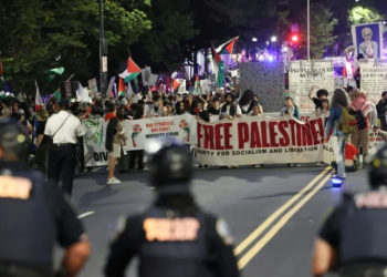 Man sets arm on fire as marches across US mark Gaza war anniversary