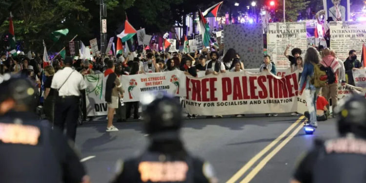 Man sets arm on fire as marches across US mark Gaza war anniversary