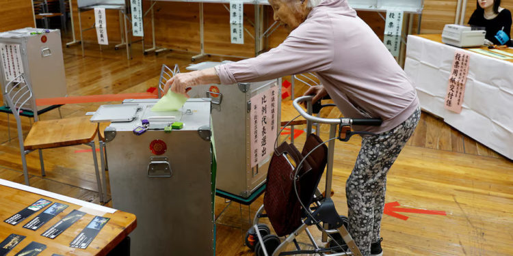 The 101-year-old Utako Kanayama casts her ballot in the general election at a polling station in Tokyo, Japan October 27, 2024. REUTERS/Kim Kyung-Hoon