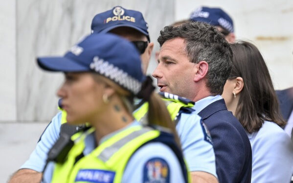 ACT Party leader David Seymour, center, looks on as thousands of people gather outside New Zealand’s parliament to protest a proposed law that would redefine the country’s founding agreement between Indigenous Māori and the British Crown, in Wellington Tuesday, Nov. 19, 2024. (AP Photo/Mark Tantrum)