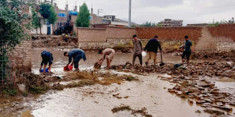 Afghans drain flood waters with shovel and buckets, after heavy rains on the outskirts of Kabul on August 20, 2024 -- the country is deemed the sixth most vulnerable to climate change (ABDUL SHAHMIM TANHA) (ABDUL SHAHMIM TANHA/AFP/AFP)