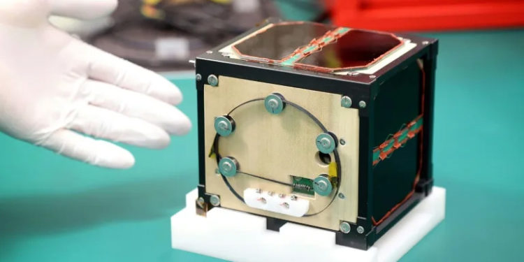 LignoSat, a satellite made from wood and developed by scientists at Kyoto University and Sumitomo Forestry, shown during a press conference in May, 2024 (STR) (STR/JIJI PRESS/AFP)