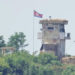 A soldier stands at a North Korean military guard post flying a national flag, seen from Paju, South Korea, on June 26, 2024. (AP Photo/Lee Jin-man, File)