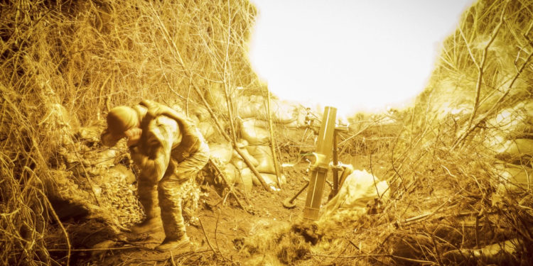 In this photo provided by Ukraine’s 24th Mechanised Brigade press service, servicemen of the 24th Mechanised Brigade fire 120mm mortar towards Russian positions near Chasiv Yar town, in Donetsk region, Ukraine, Tuesday, Nov. 19, 2024. (Oleg Petrasiuk/Ukrainian 24th Mechanised Brigade via AP)