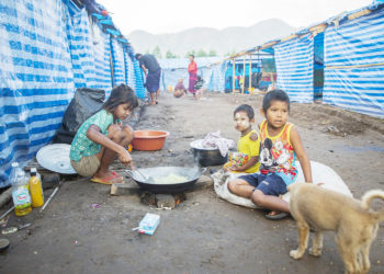 Myanmar refugee children, who fled a surge in violence as the military cracks down on rebel groups in February 2022, cook at a camp near the Myanmar-Thailand border in Kayin state. (AFP)
