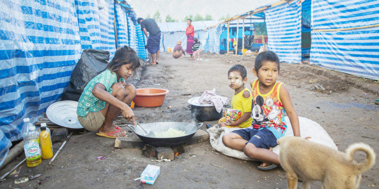 Myanmar refugee children, who fled a surge in violence as the military cracks down on rebel groups in February 2022, cook at a camp near the Myanmar-Thailand border in Kayin state. (AFP)