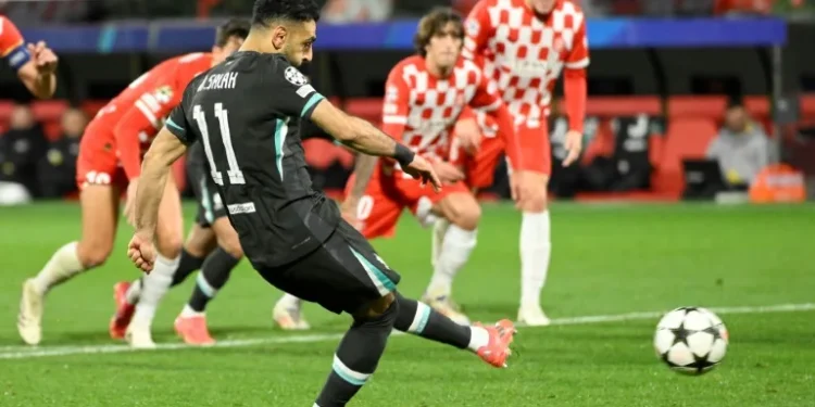 Spot on: Mohamed Salah's penalty in Girona gave Liverpool their sixth win out of six (Josep LAGO)